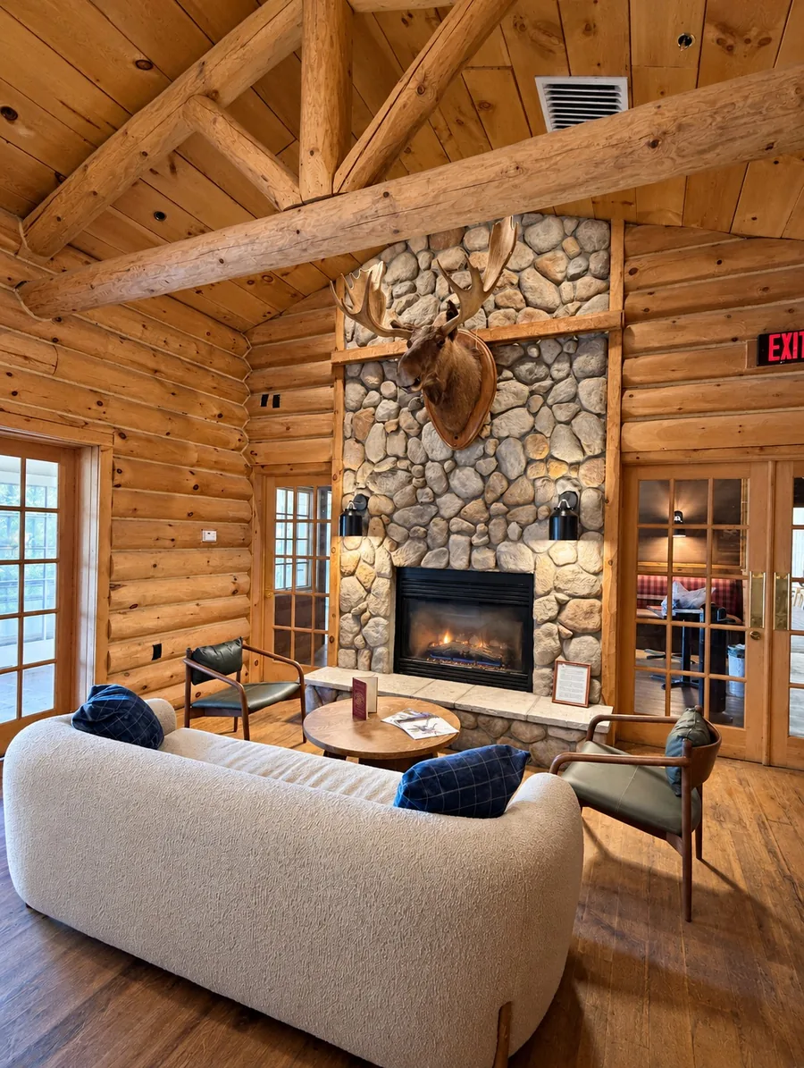 The Public House Lounge: timber walls and a stone fireplace