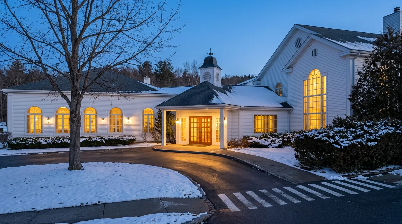 Artist's impression: the Public House entrance at blue hour on a winter evening, windows lit warm gold